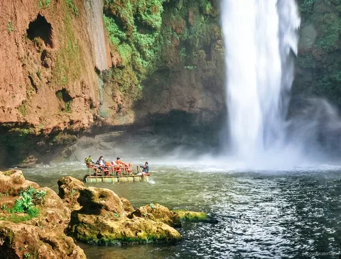 Traditional wooden boat ride at the base of Ouzoud Waterfalls near Marrakech