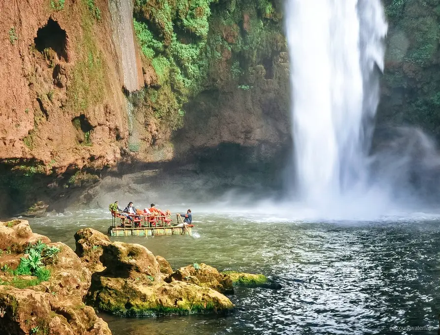 Traditional wooden boat ride at the base of Ouzoud Waterfalls near Marrakech
